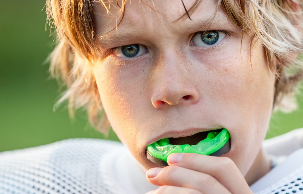 Boy putting in his mouth guard